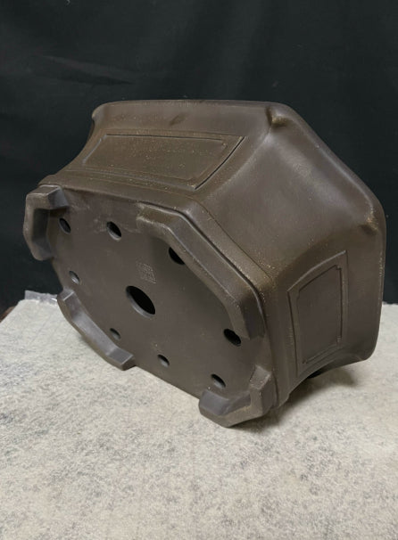Underside and side panel of dark brown clipped-corner pot