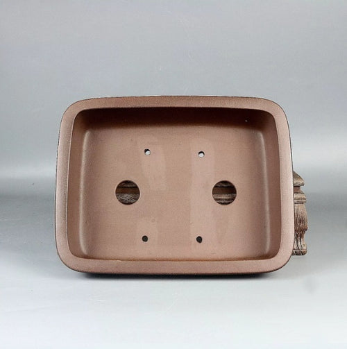 Interior of a soft-corner brown rectangular pot with two drainage holes