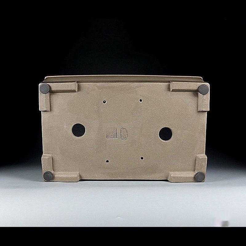 Underside of taupe rectangular pot showing two large openings and corner feet
