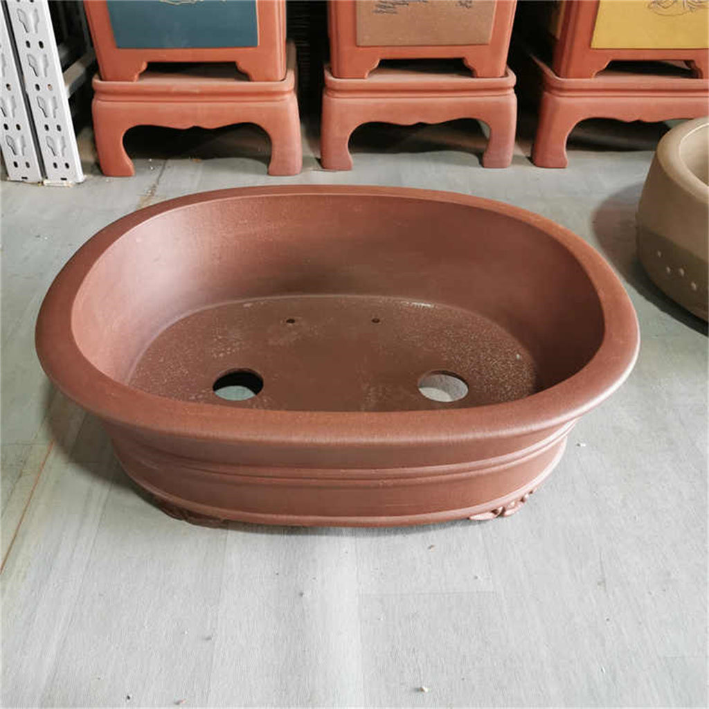 Angled interior view of brown oval pot with two large openings