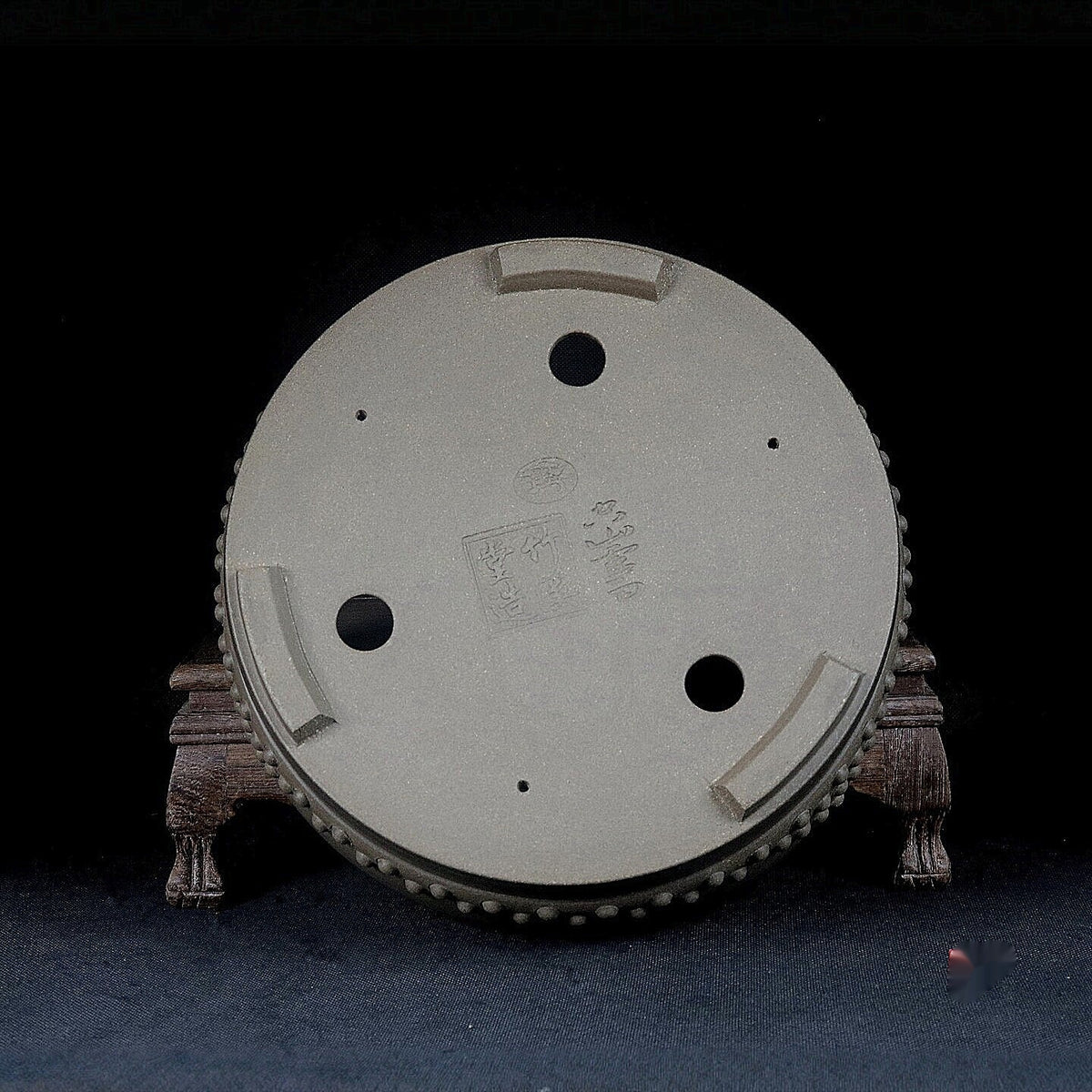 Gray drum bonsai pot underside showing drainage and wiring openings