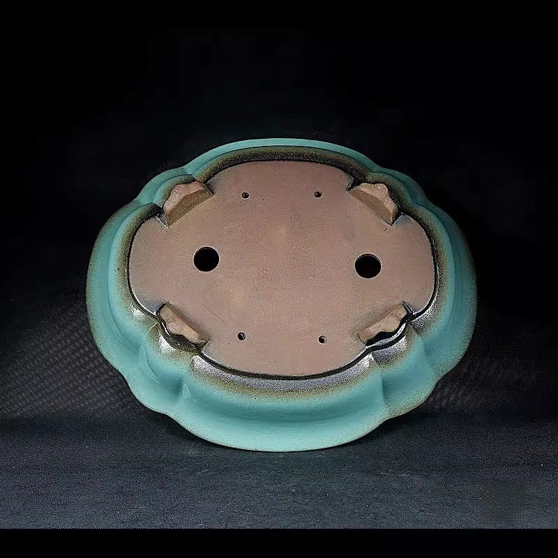 Mokko pot underside showing drainage and wiring holes