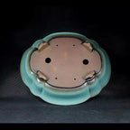 Mokko pot underside showing drainage and wiring holes