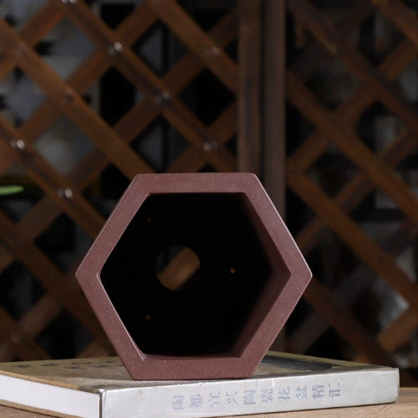 Top view of tall hexagonal pot showing dark interior and base opening