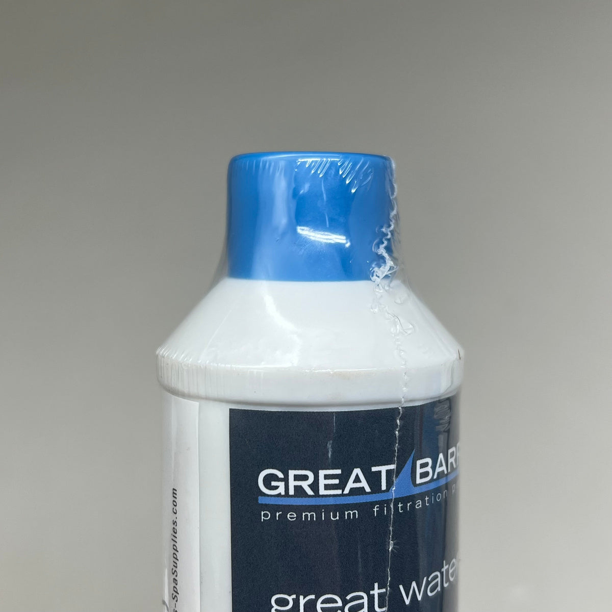 Close-up of the filter's blue protective cap and white neck