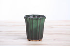 Angled view of the dark green tall fluted bonsai pot showing its rim and side profile