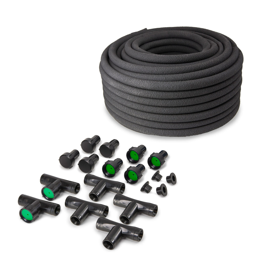 Coiled black soaker hose with assorted tee fittings, connectors, caps and green flow inserts