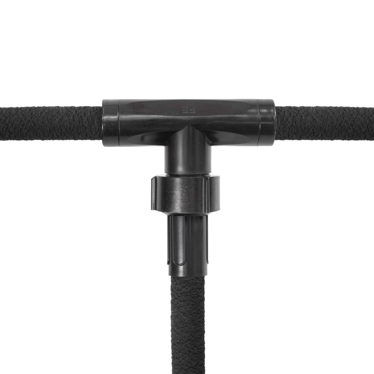 Close-up of three soaker hose sections joined by a black tee fitting