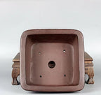 Top view of brown square pot showing central opening and four small holes