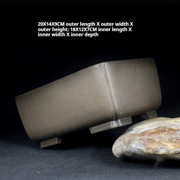 Gray-brown rectangular pot tilted on a stone with measurement labels