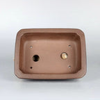 Interior of the brown rectangular pot with two drainage holes