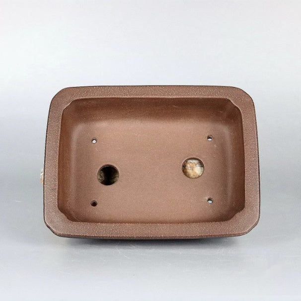 Interior of the brown rectangular pot with two drainage holes
