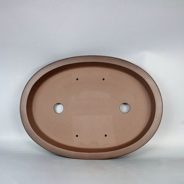 Top view of brown oval pot showing two large openings and four small holes