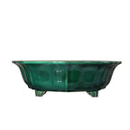 Isolated green-glazed lobed pot with short feet