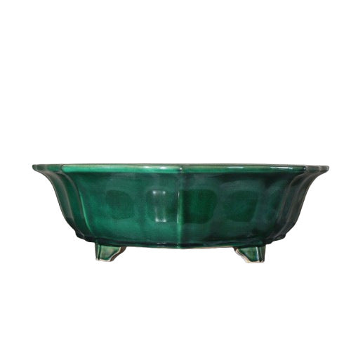 Isolated green-glazed lobed pot with short feet