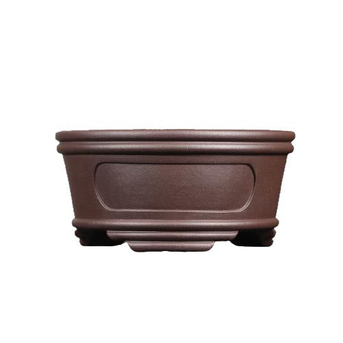 Isolated front view of brown round pot with recessed oval panel