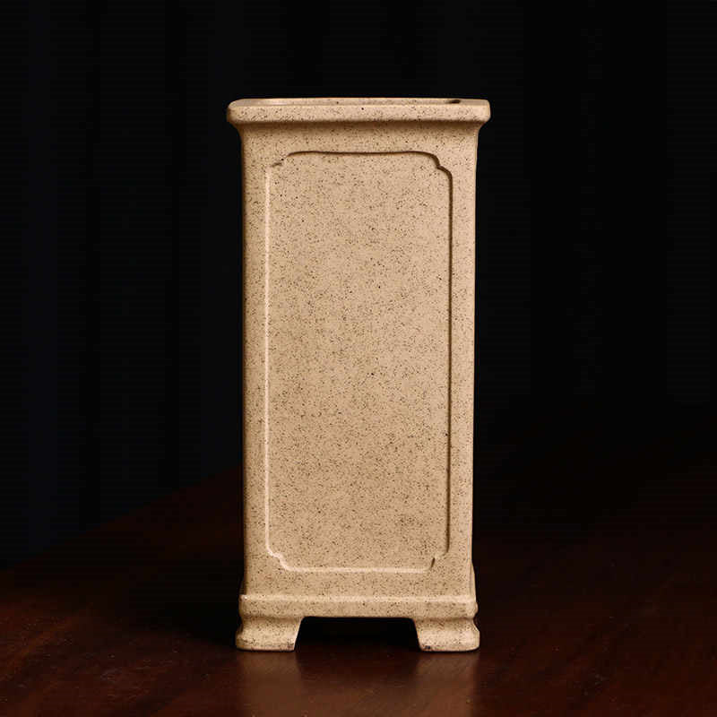 Front view of tall pale tan square pot with framed panel
