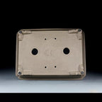 Underside of taupe rectangular pot showing two large openings and corner feet
