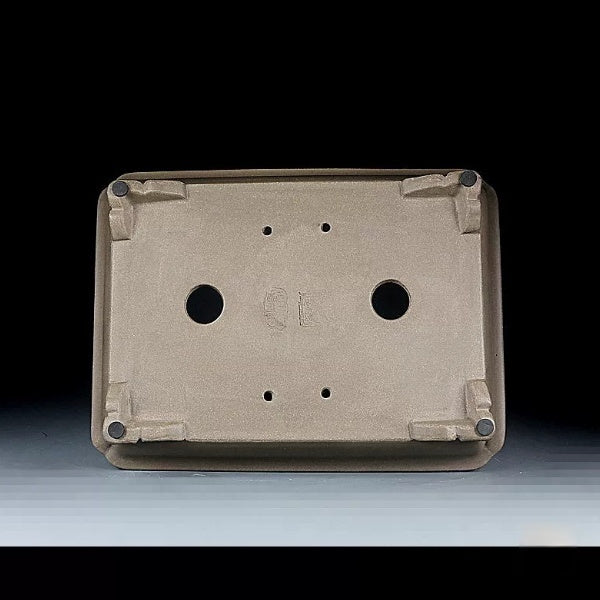 Underside of taupe rectangular pot showing two large openings and corner feet