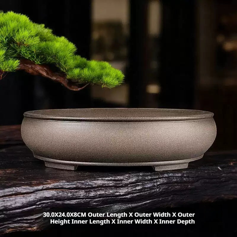 Taupe oval pot displayed on wood with dimension annotations