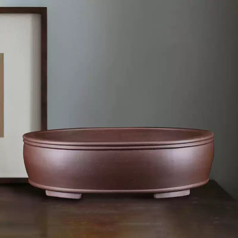 Brown oval bonsai pot with double rim and low block feet