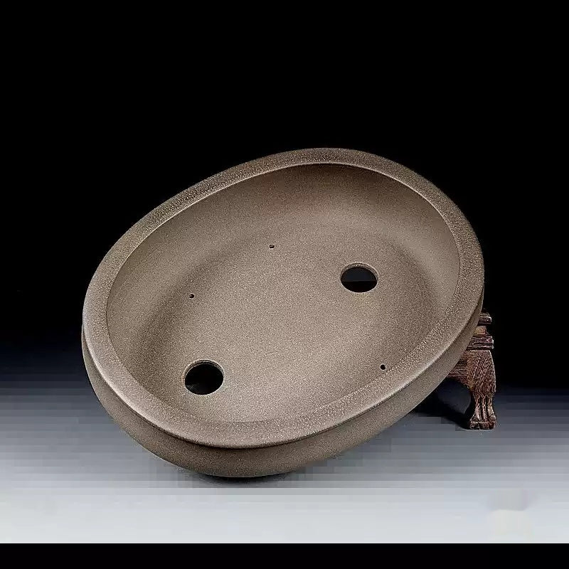 Interior of the taupe oval pot showing two drainage holes