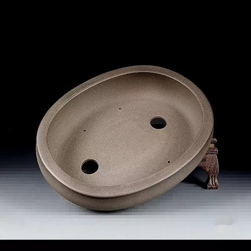 Interior of the taupe oval pot showing two drainage holes