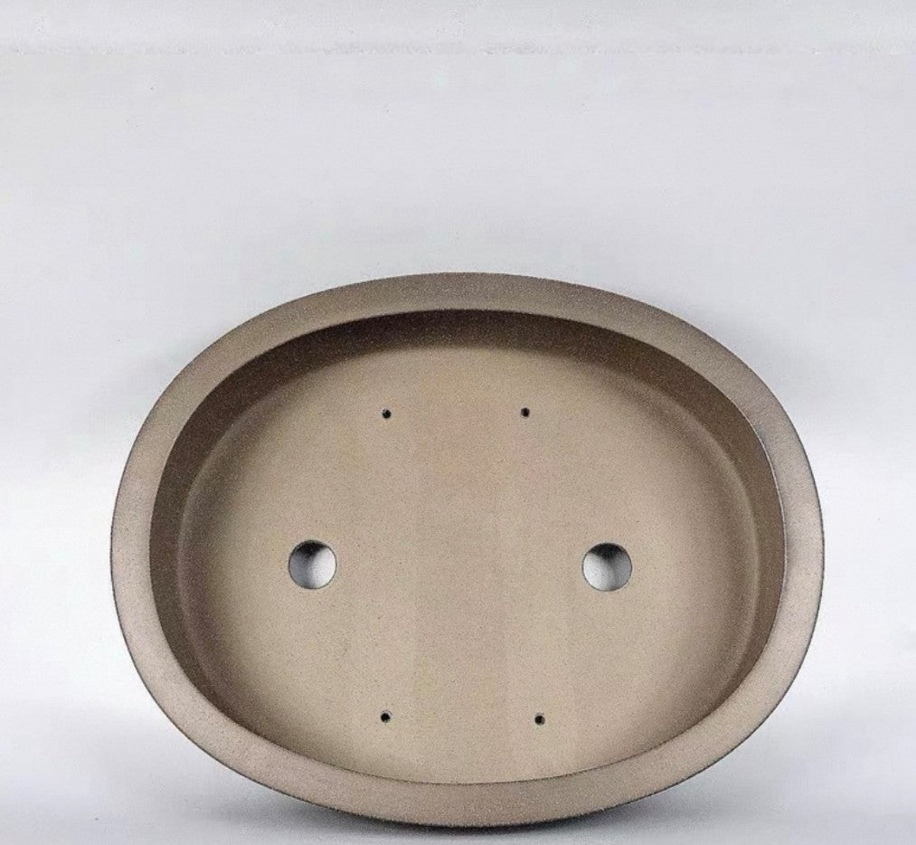 Interior of the taupe oval pot showing drainage and smaller openings