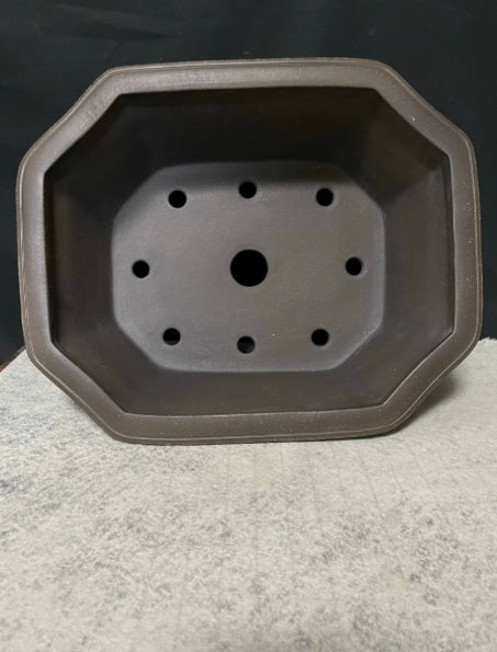 Top view of clipped-corner pot showing one large opening surrounded by smaller holes