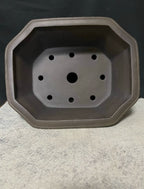 Top view of clipped-corner pot showing one large opening surrounded by smaller holes