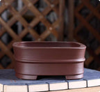 Front profile of brown rounded square pot with raised band