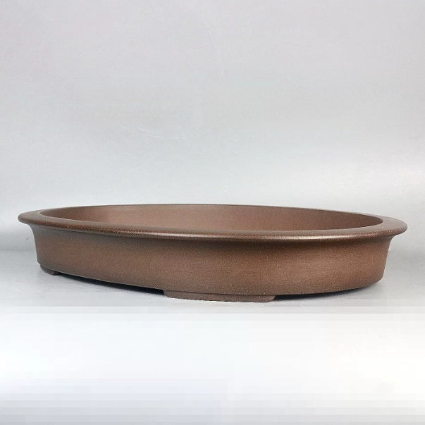 Shallow brown oval bonsai pot with broad rim and low feet