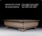 Cloud feet and rounded corner detail of taupe rectangular pot