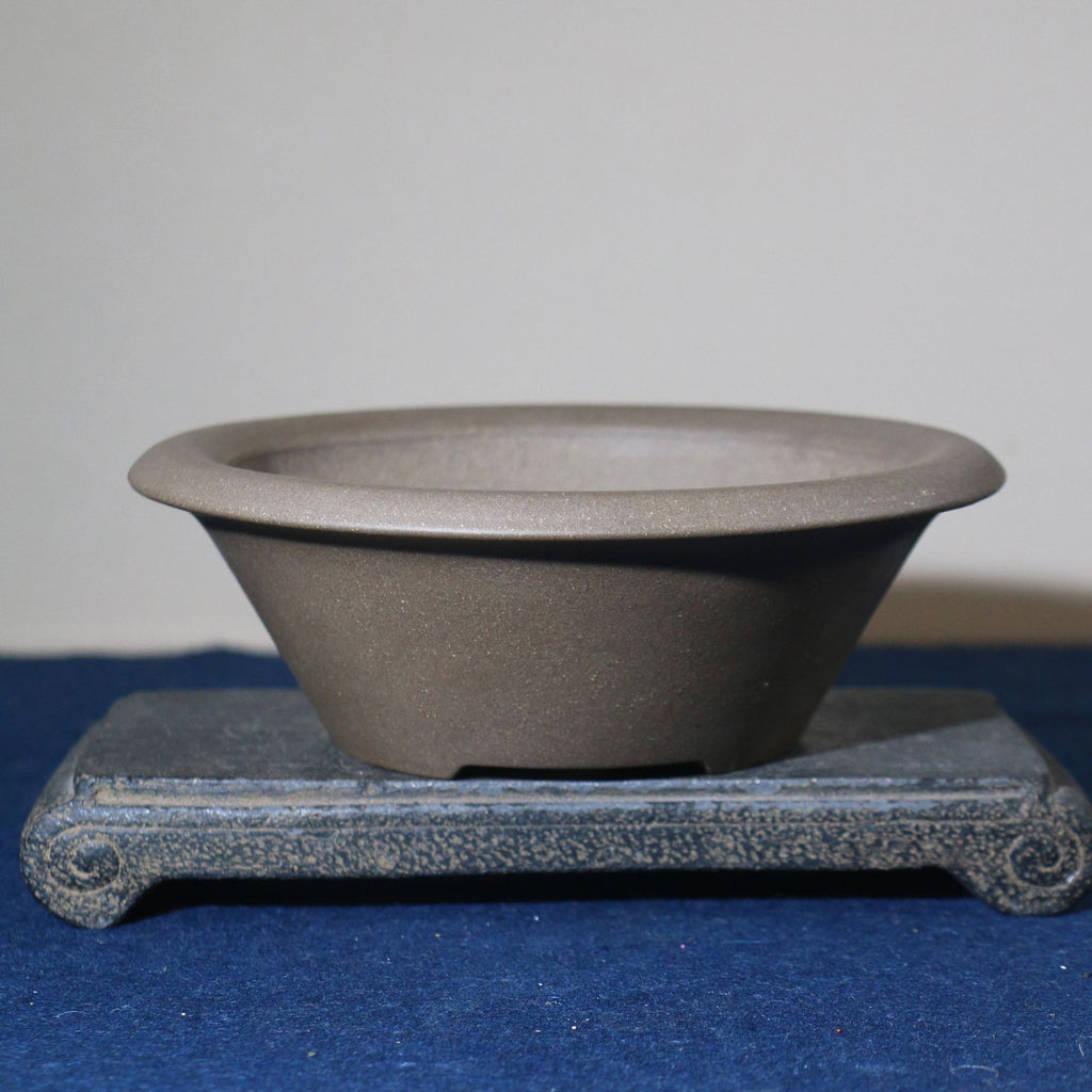 Angled gray conical pot showing open rim and tapered wall