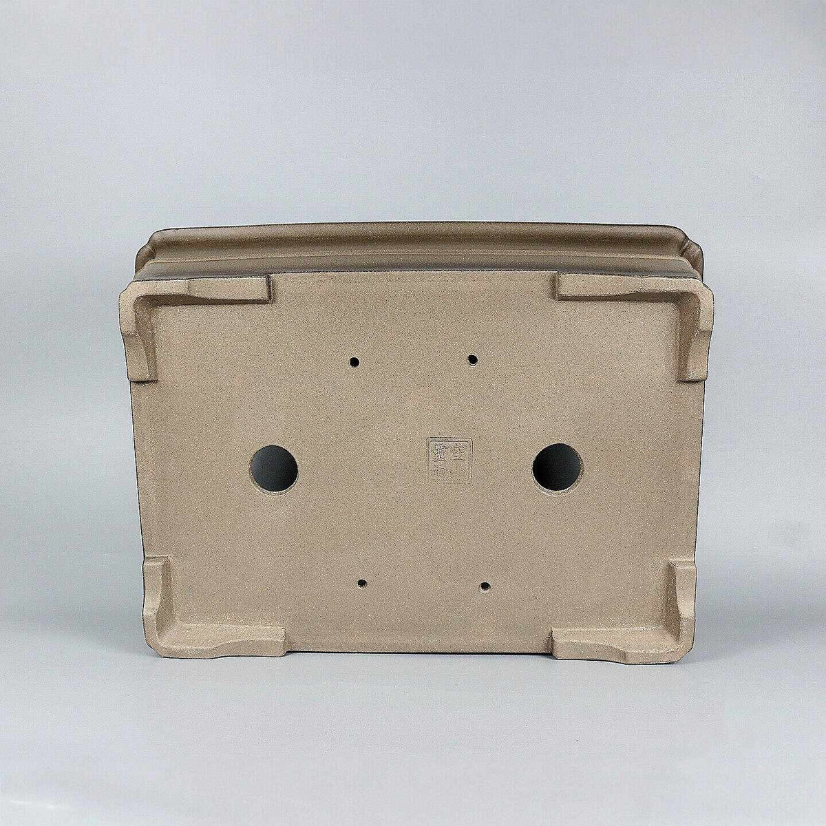 Underside of taupe rectangular pot showing openings and corner feet