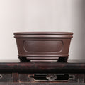 Front profile of brown round pot on a wooden stand