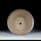 Interior of the deep taupe pot with central drainage opening