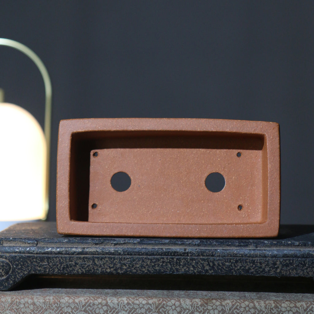 Interior of the rectangular pot showing two drainage holes