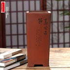 Tall reddish-brown square pot with calligraphy on front