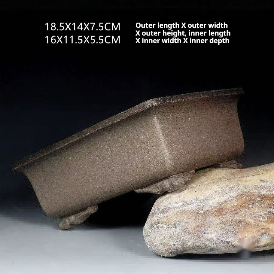 Taupe rectangular pot tilted on a stone with measurement labels