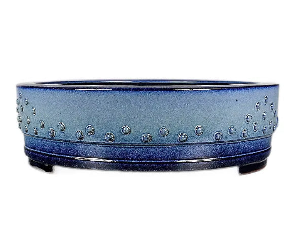 Angled view of the blue studded drum pot with low feet