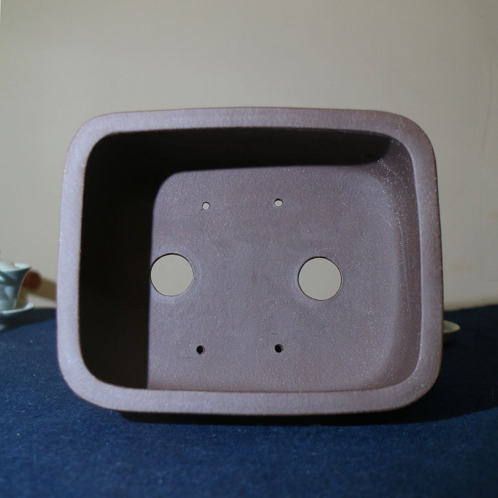 Top view of purple-brown rectangular pot showing two large openings and four small holes