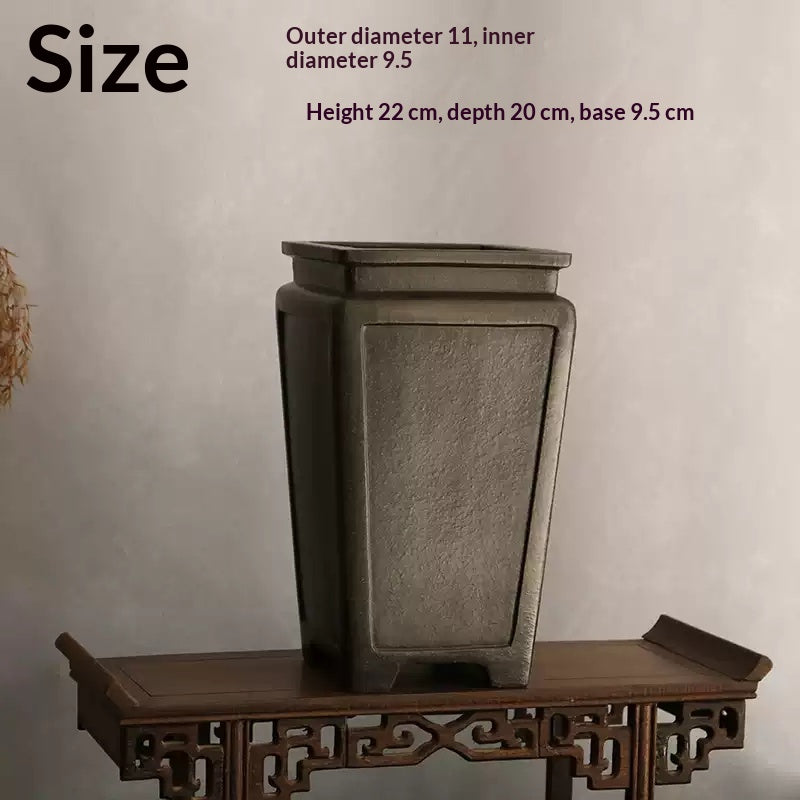 Tall charcoal square pot on carved stand with measurement labels