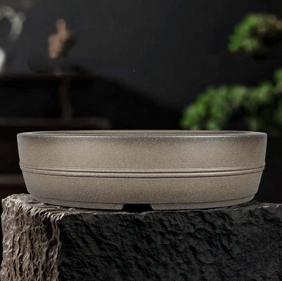 Taupe oval pot with two narrow horizontal bands and low feet