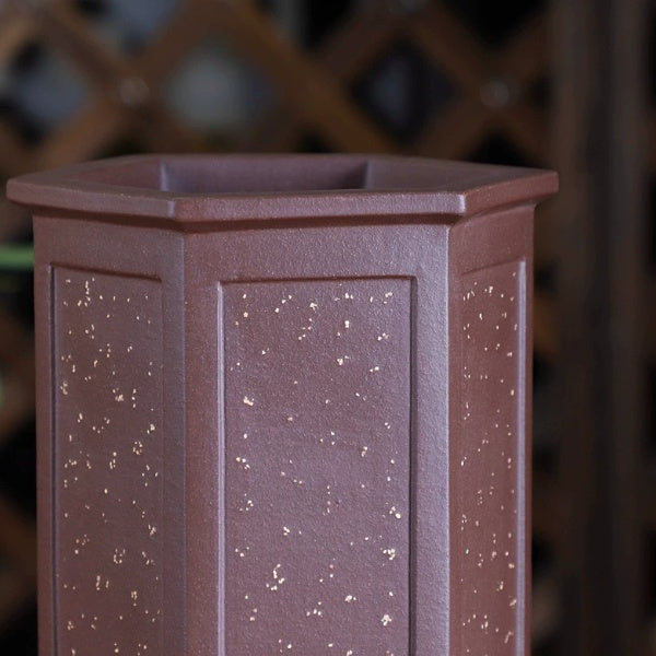 Close-up of speckled reddish-brown hexagonal pot showing paneled sides