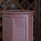Close-up of speckled reddish-brown hexagonal pot showing paneled sides