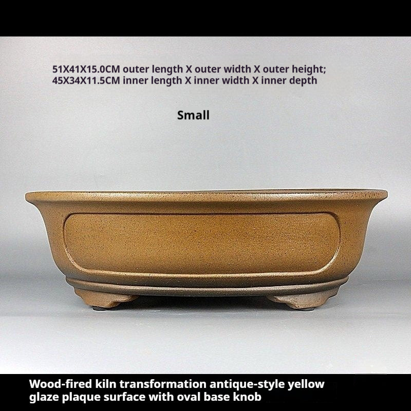 Front view of ochre oval pot with measurement labels