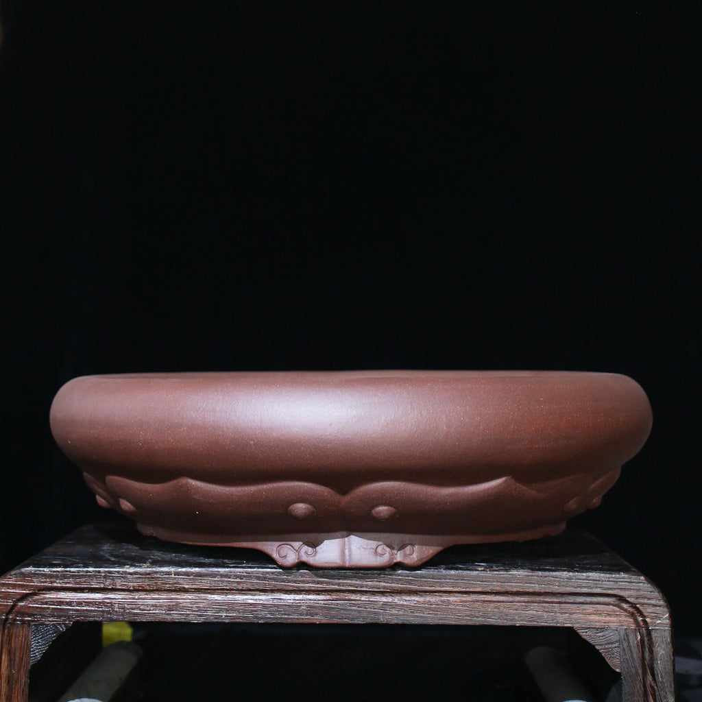 Front view of brown round pot with broad rolled rim
