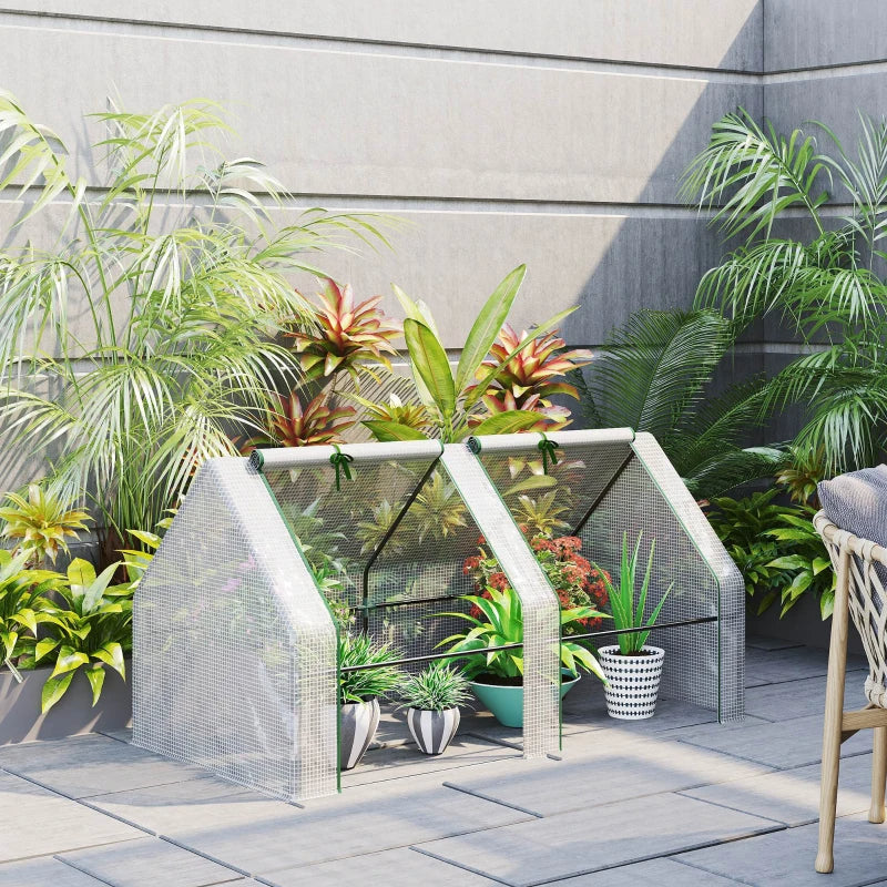 Two-door mini greenhouse shown with potted plants on a patio