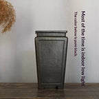 Front view of tall dark square pot with lighting annotation